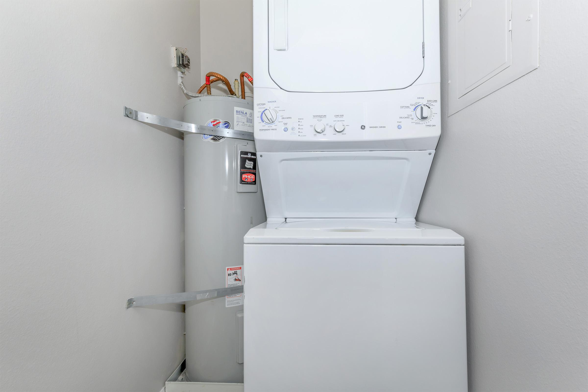 a microwave oven sitting on top of a refrigerator