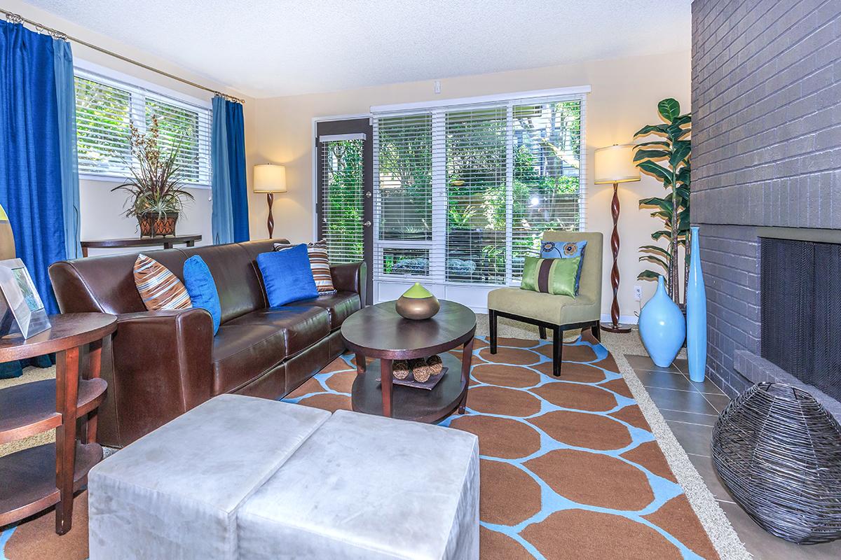 a living room filled with furniture and a large window