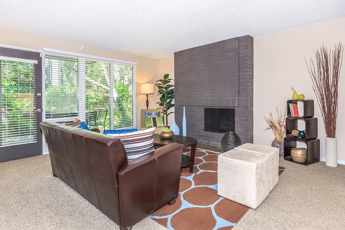 a living room filled with furniture and a large window