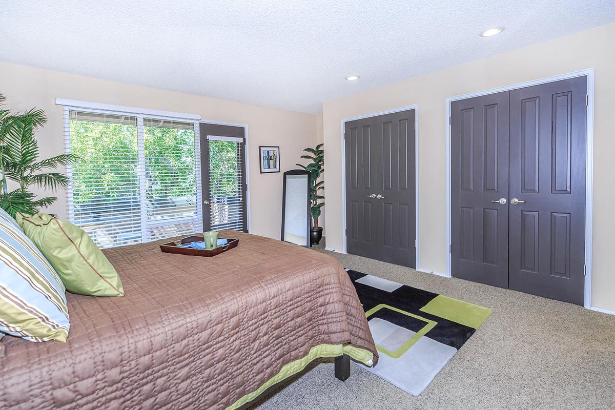 a bedroom with a bed in a room