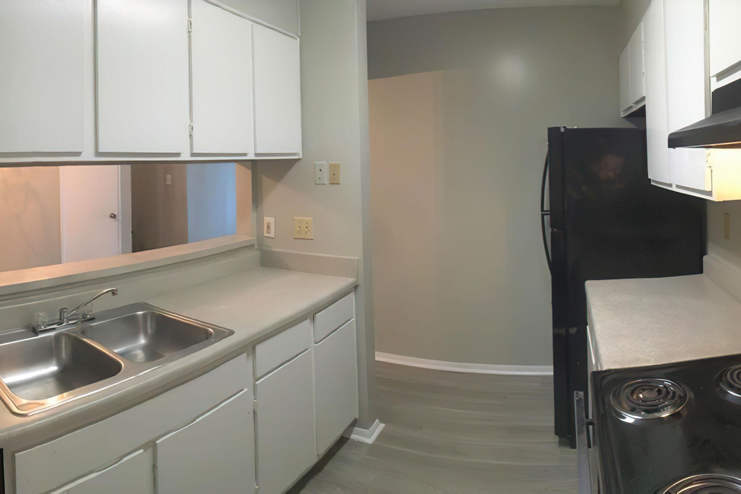 a stove top oven sitting inside of a kitchen