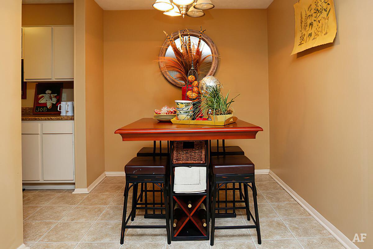 a room filled with furniture and vase of flowers on a table