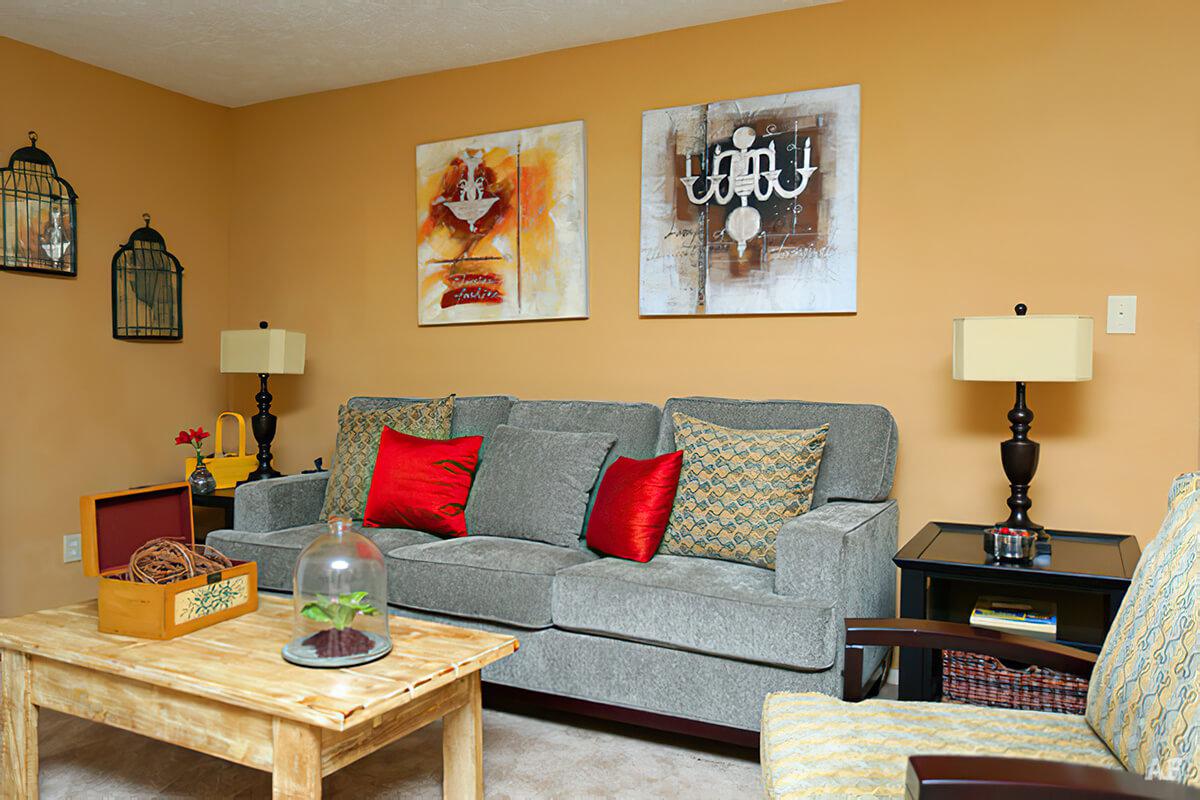 a living room filled with furniture and vase on a table