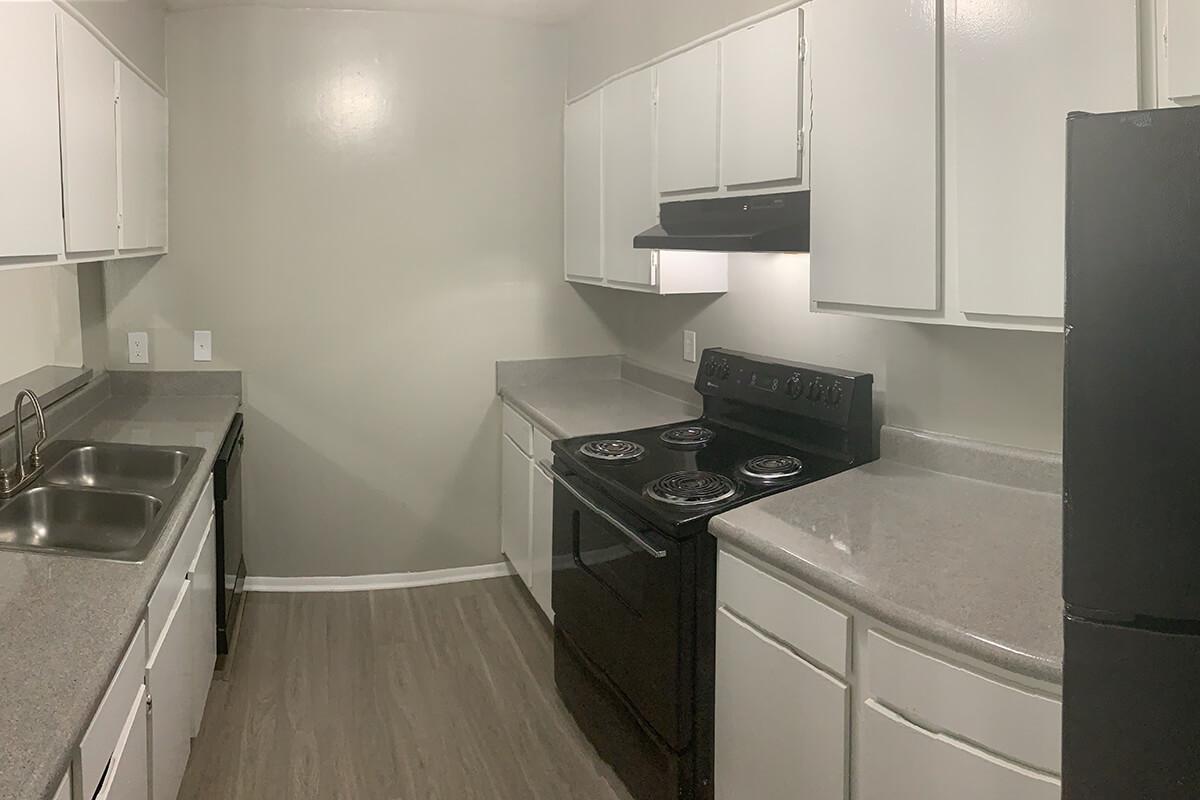 a kitchen with a stove sink and refrigerator