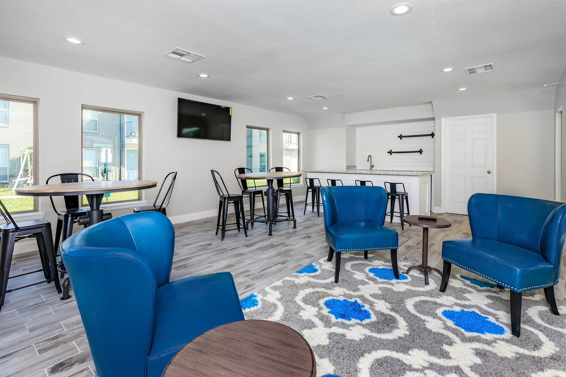 a living room filled with furniture and a blue chair