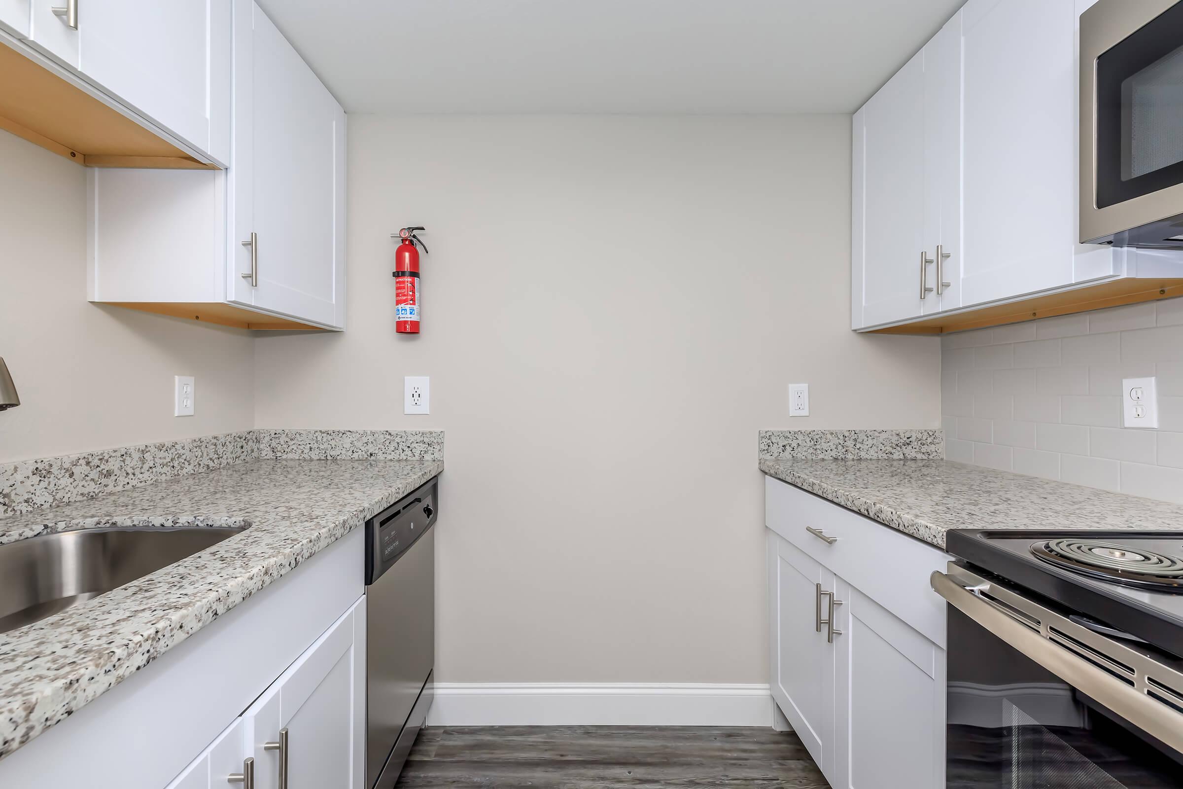 a kitchen with a sink and a mirror