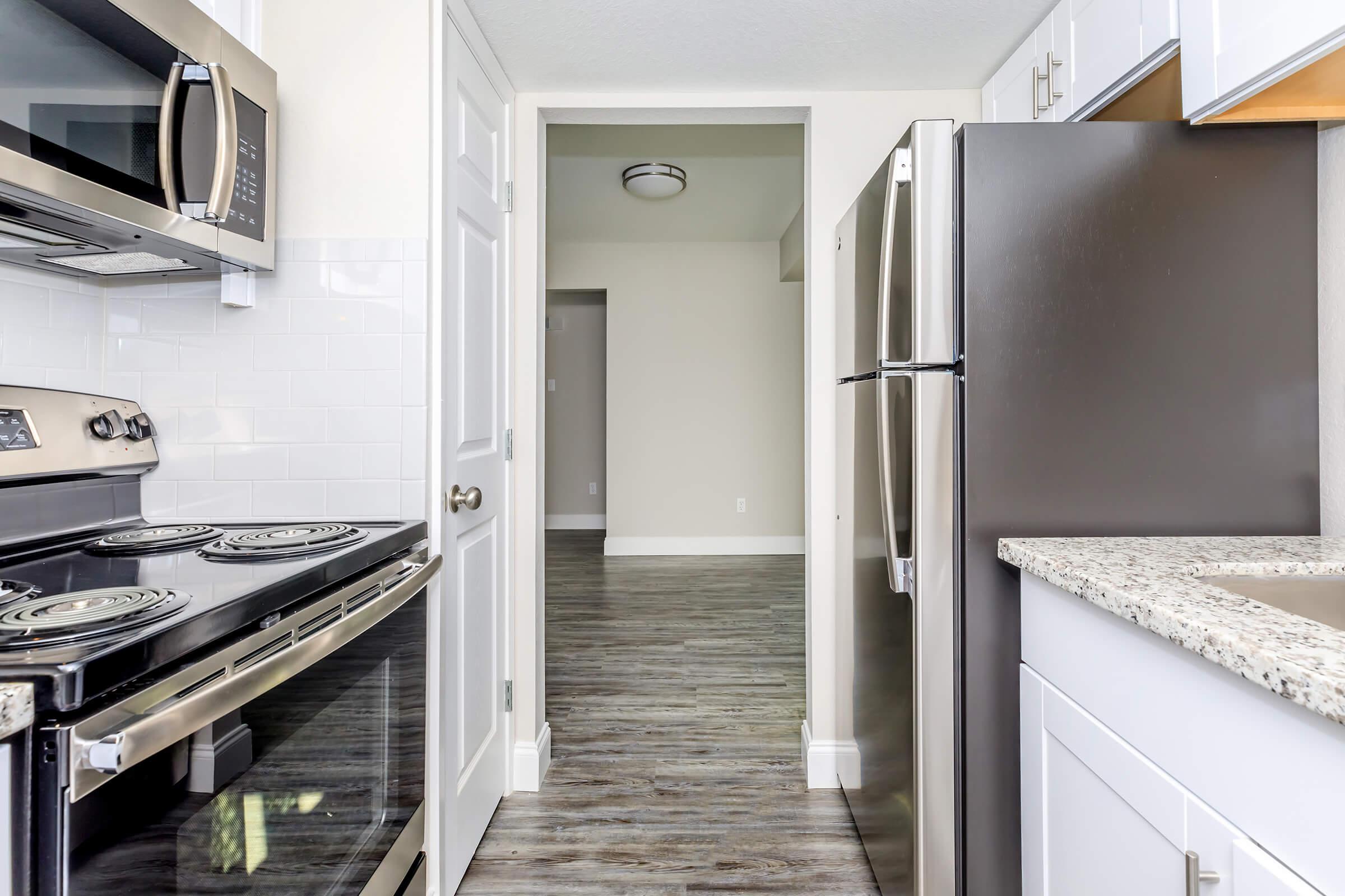 a kitchen with a stove top oven sitting inside of a building