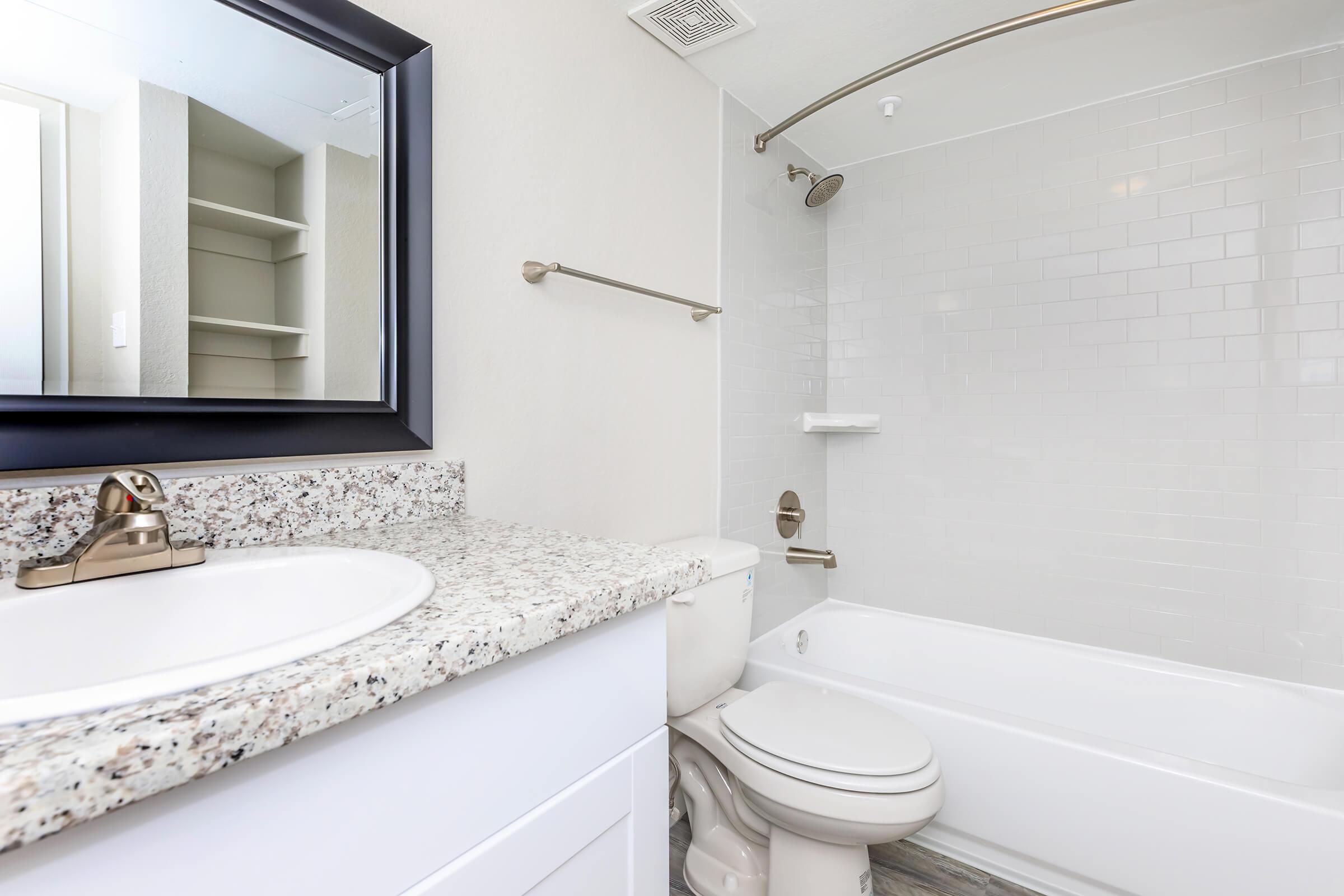 a white sink sitting under a window