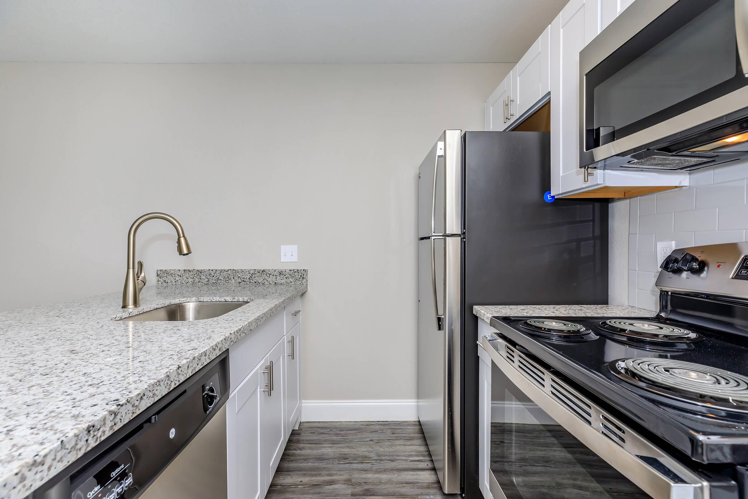 a stove top oven sitting inside of a kitchen