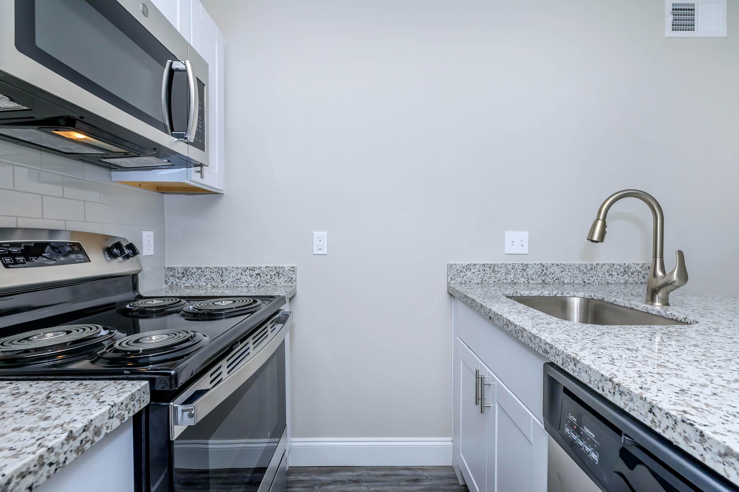 a kitchen with a stove and a sink