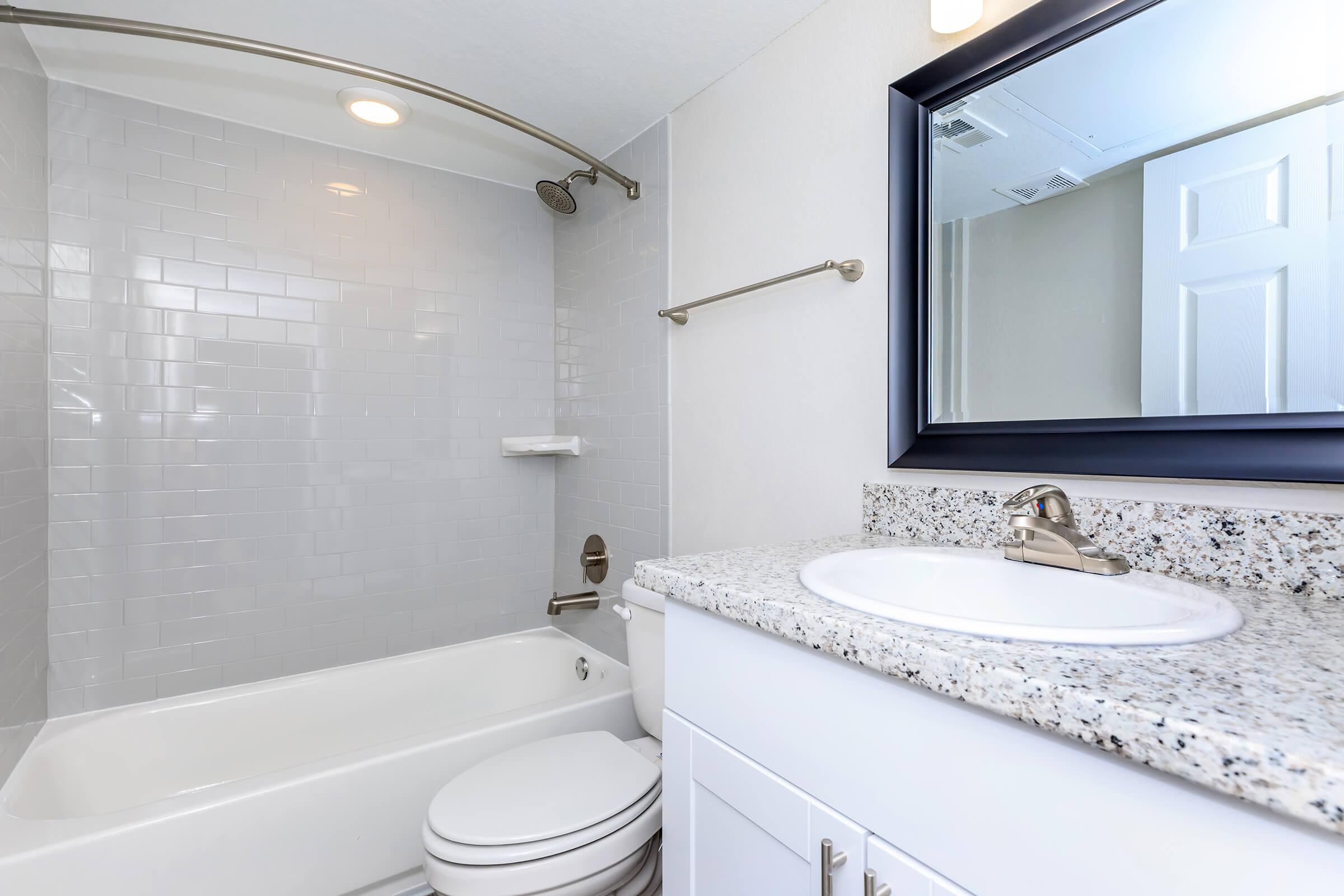 a large white tub next to a sink