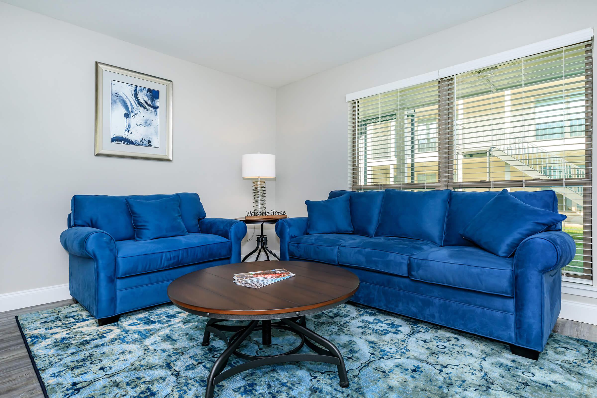 a living room with blue furniture