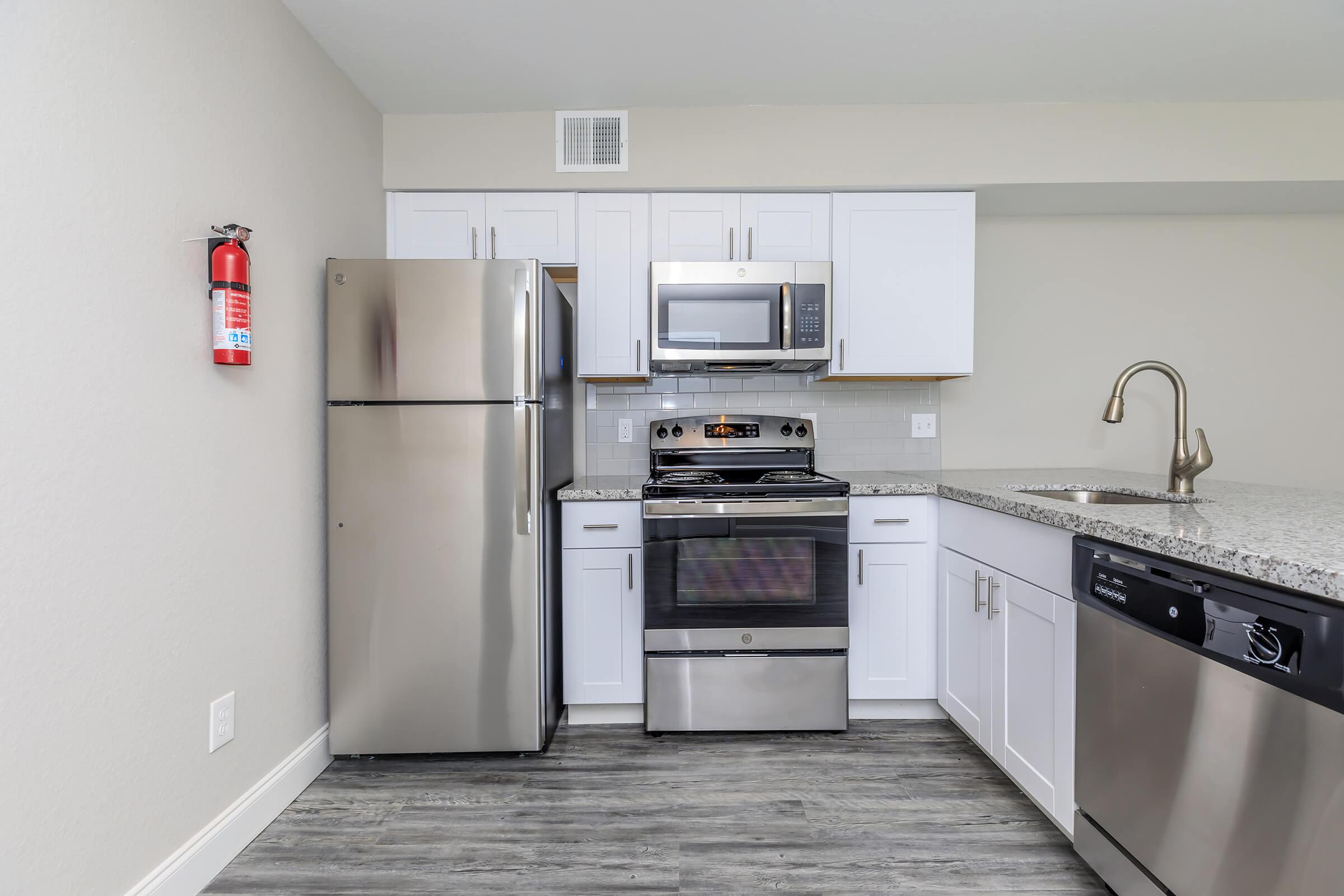 a white refrigerator freezer sitting inside of a kitchen