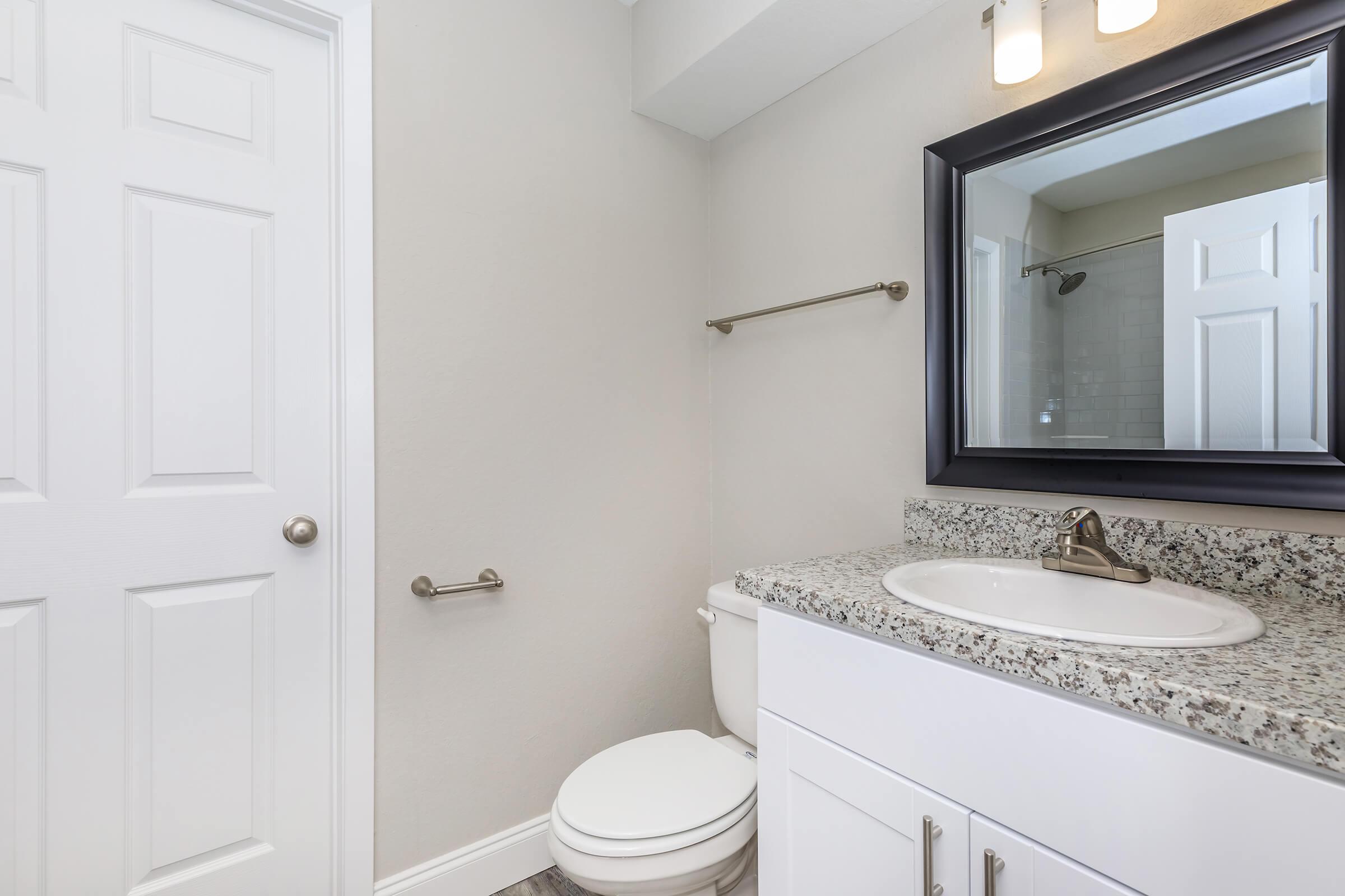 a white sink and a mirror