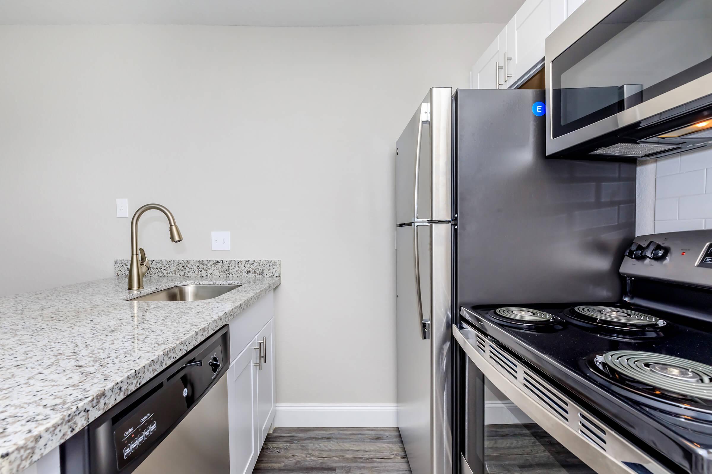 a stove top oven sitting inside of a kitchen