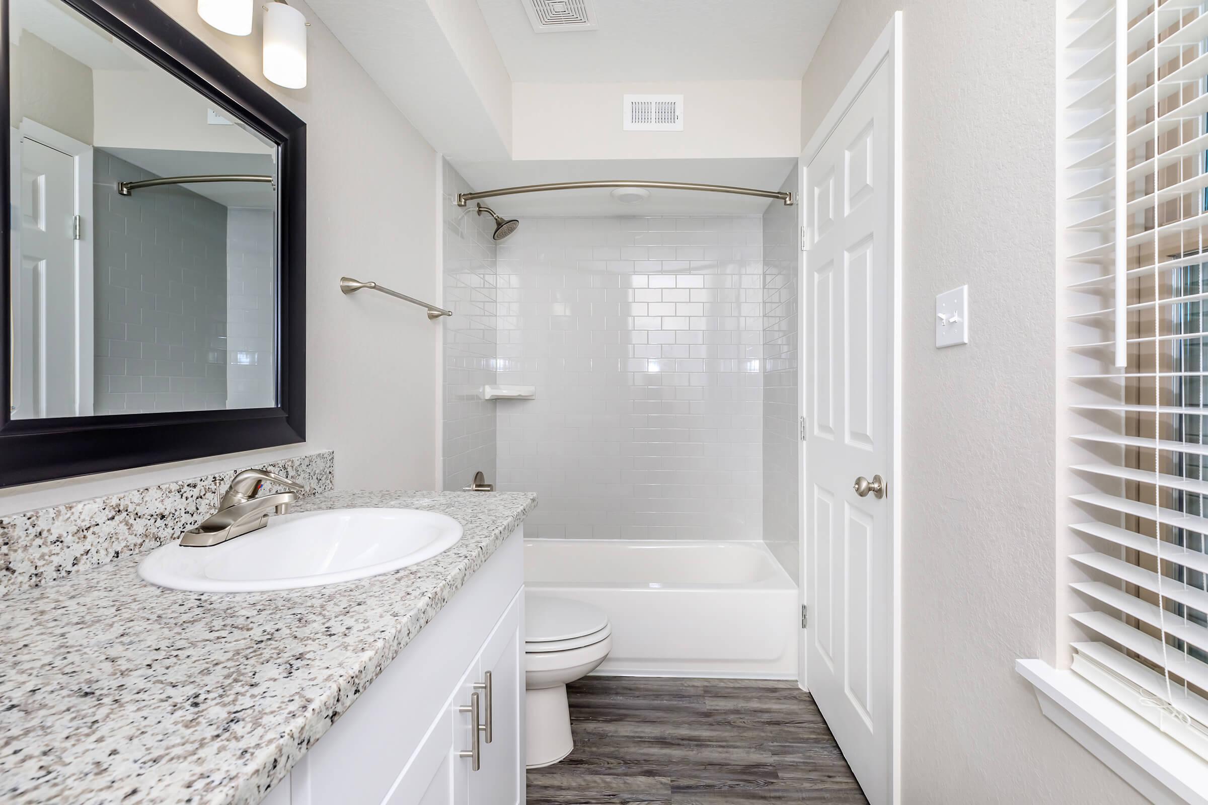 a large white tub next to a window