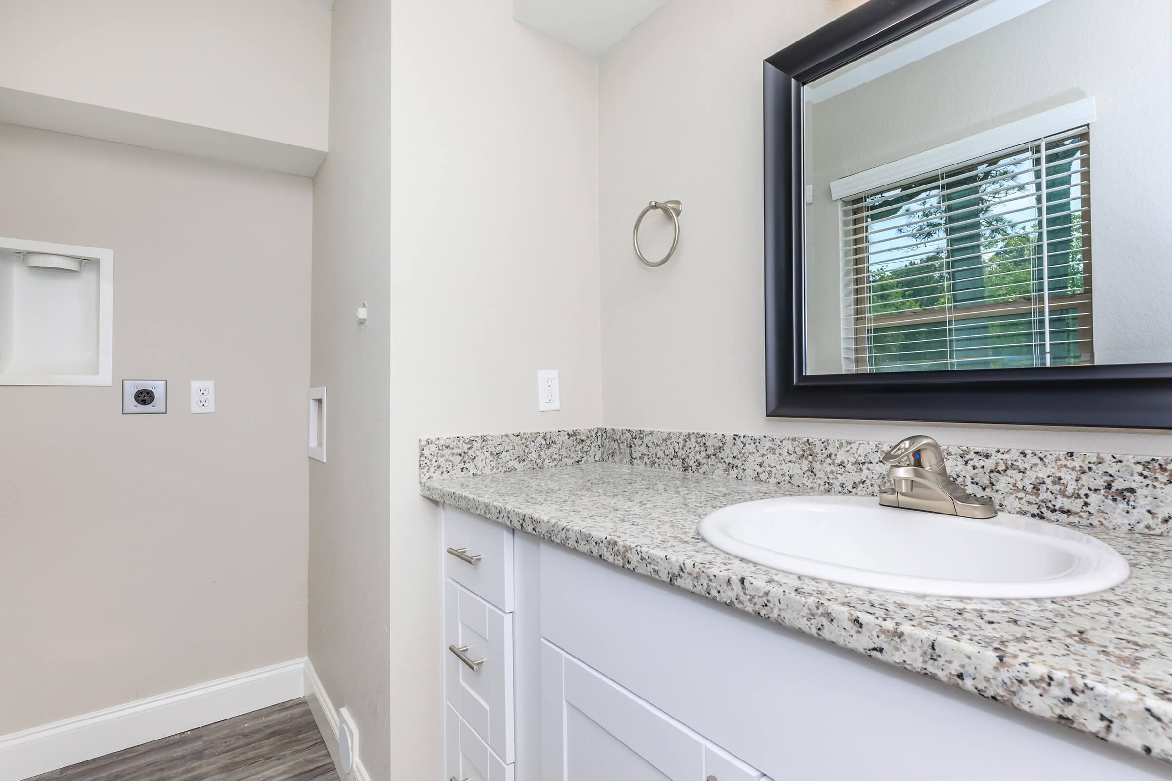 a white sink and a mirror