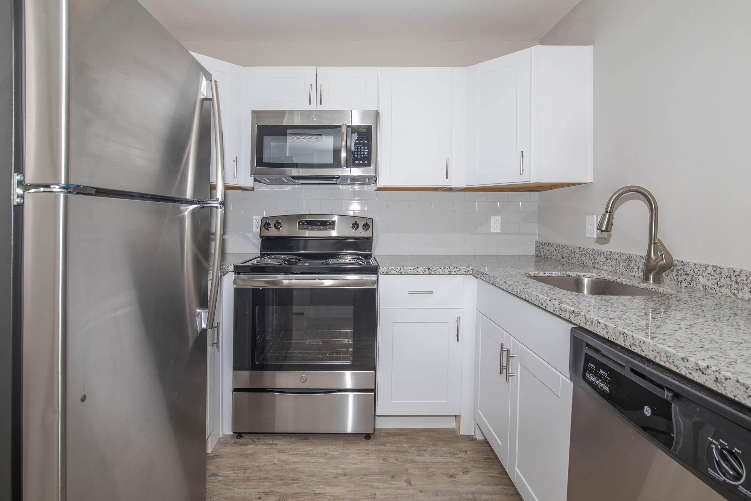 a large kitchen with stainless steel appliances