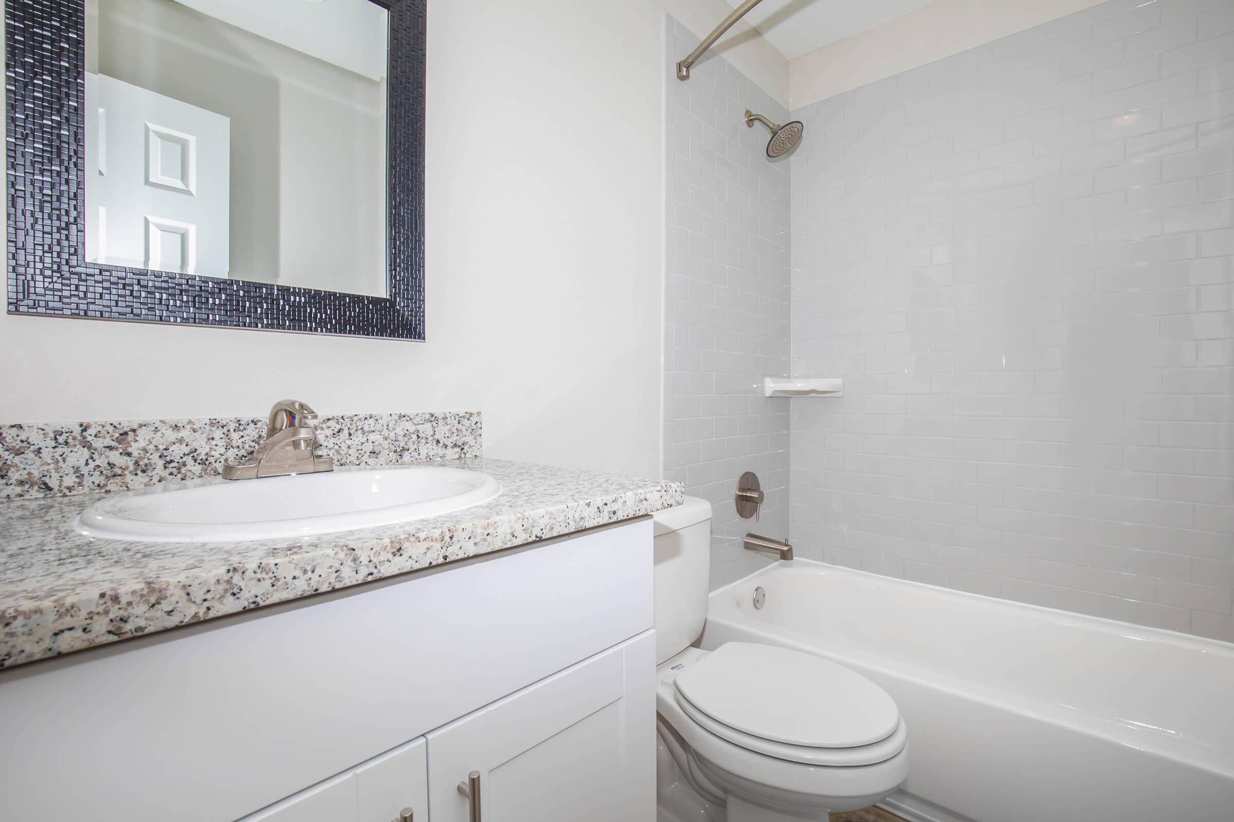 a white tub sitting next to a sink