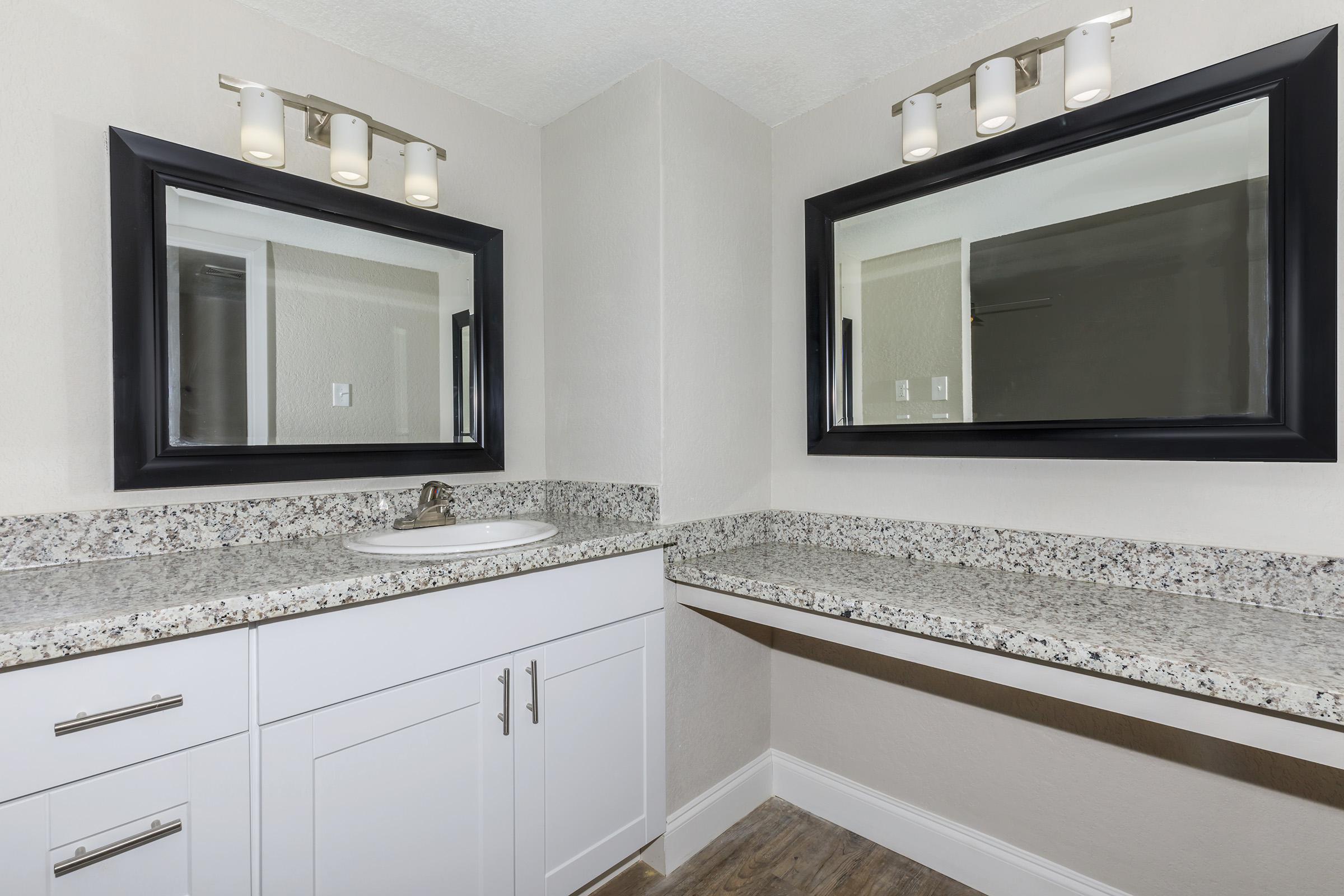 a kitchen with a sink and a mirror