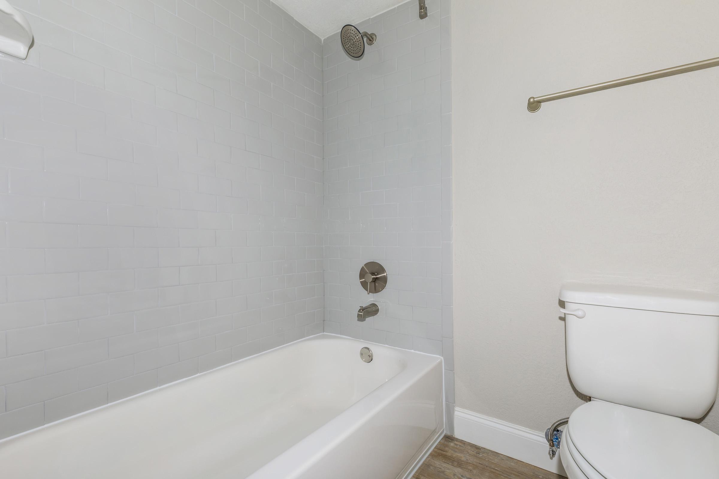 a white tub sitting next to a shower