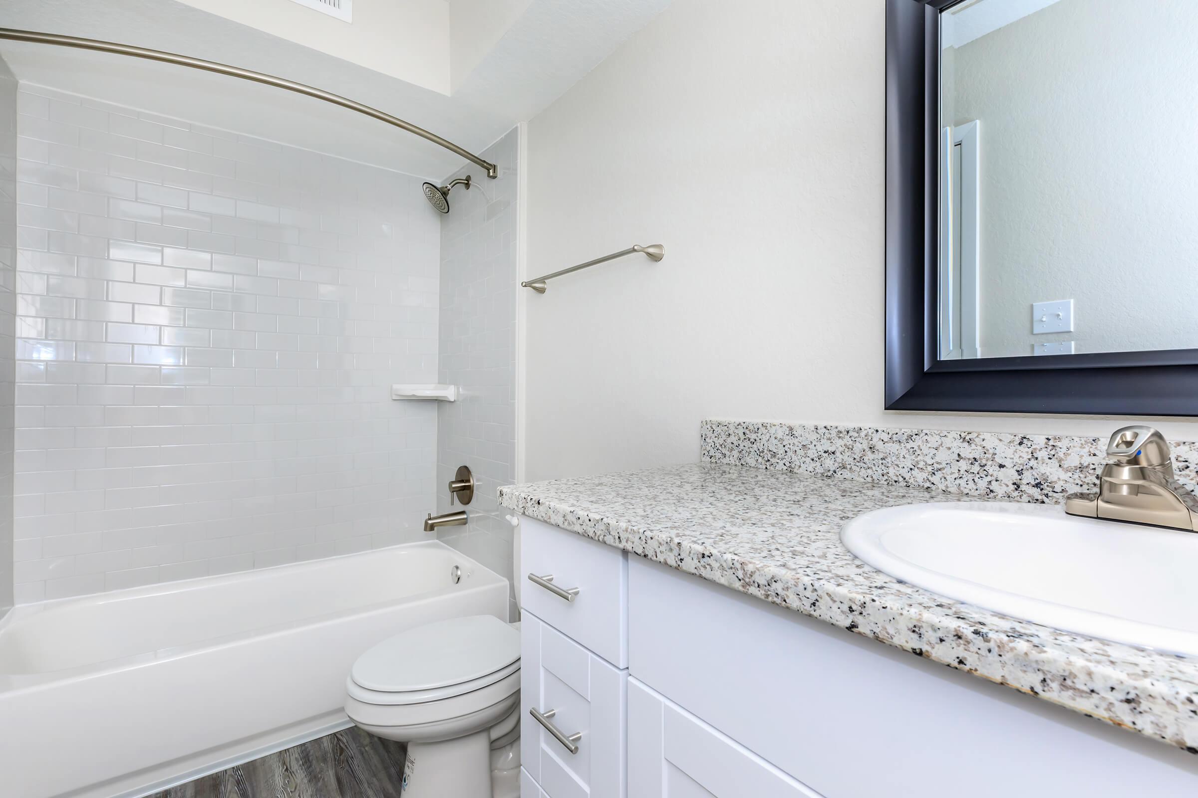 a large white tub next to a sink