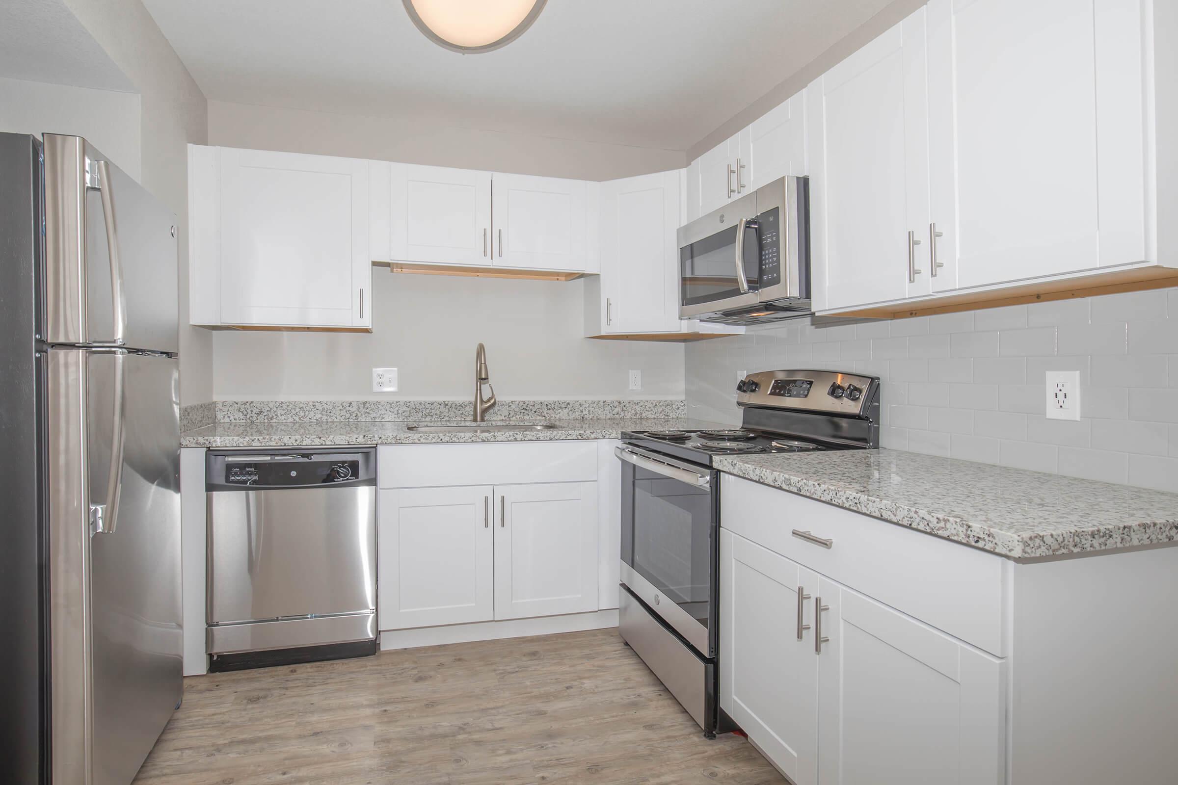 a kitchen with a sink and a refrigerator