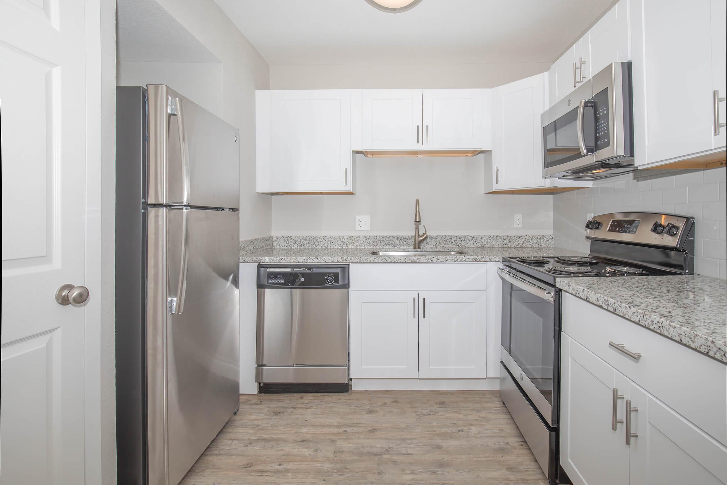 a kitchen with a sink and a refrigerator