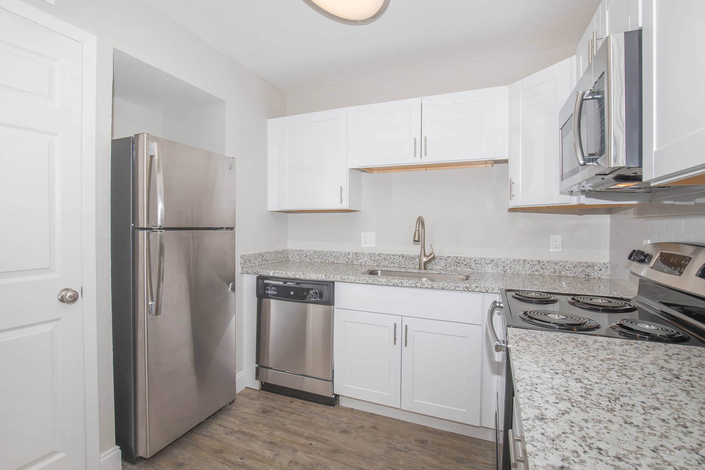 a kitchen with a stove sink and refrigerator