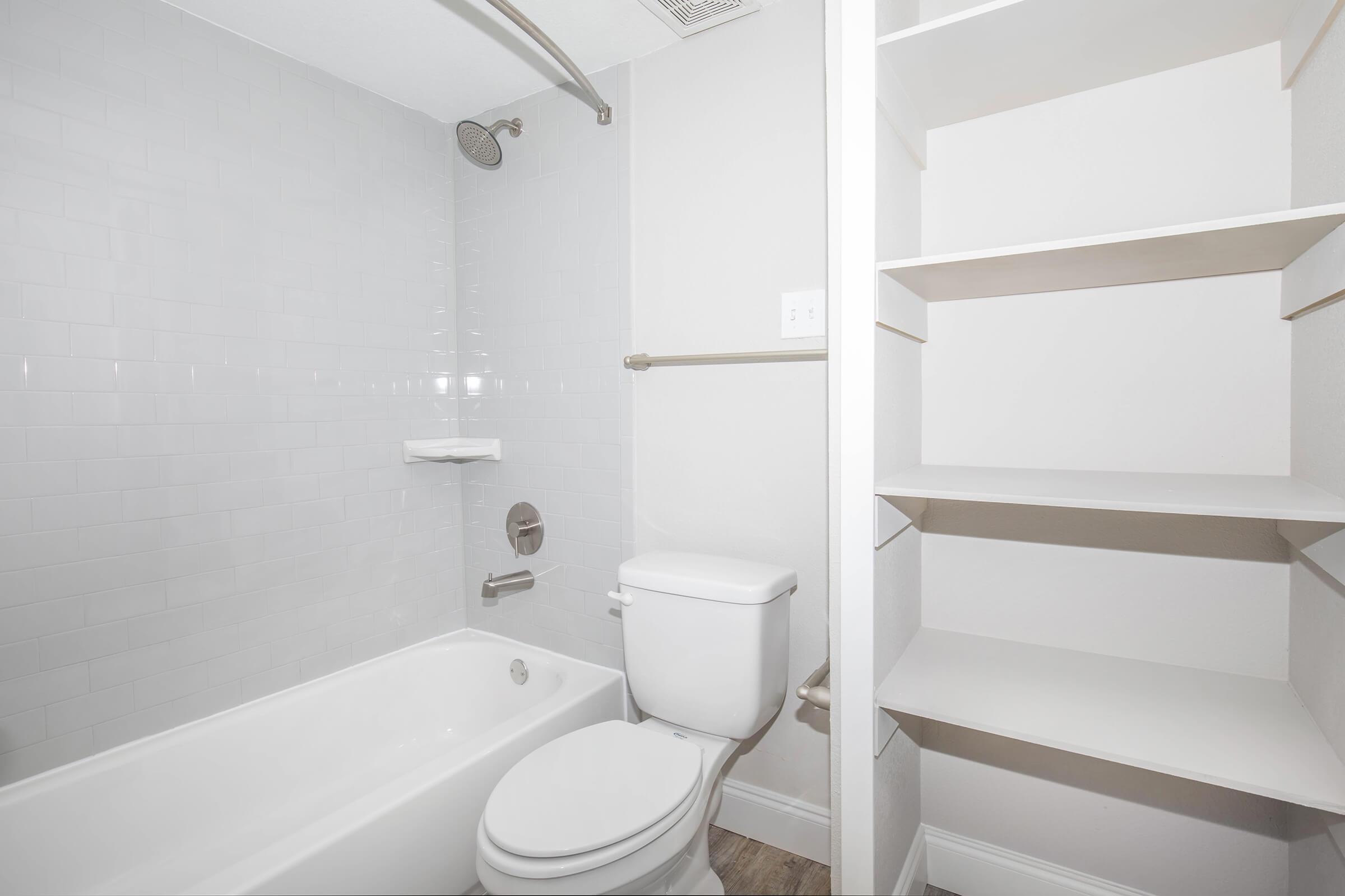 a white tub sitting next to a shower