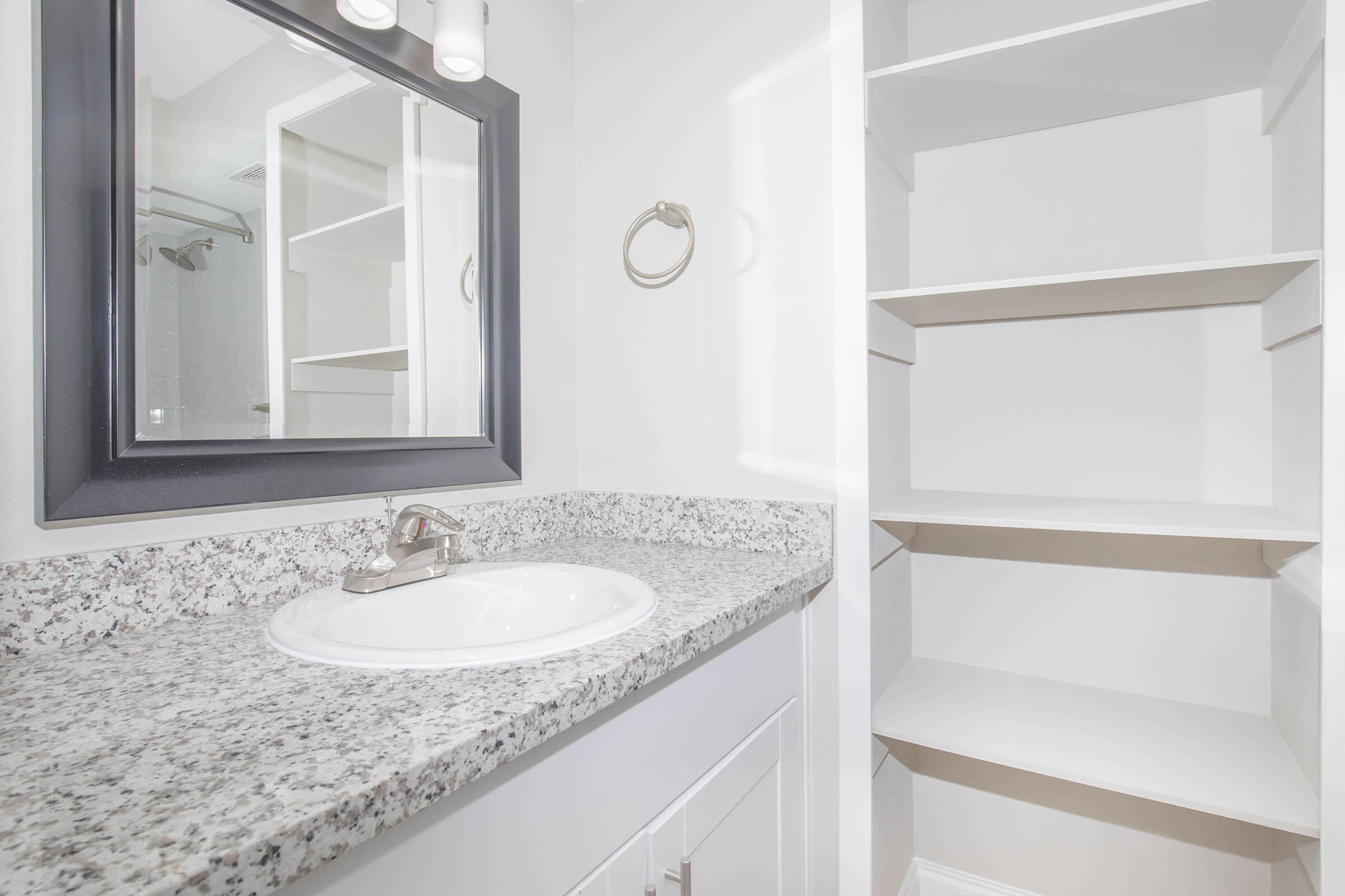 a white sink sitting under a window