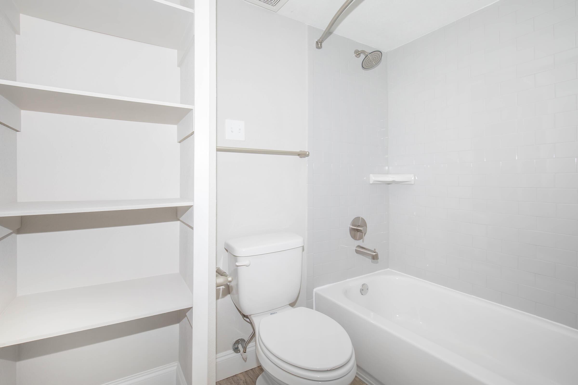 a white tub sitting next to a shower