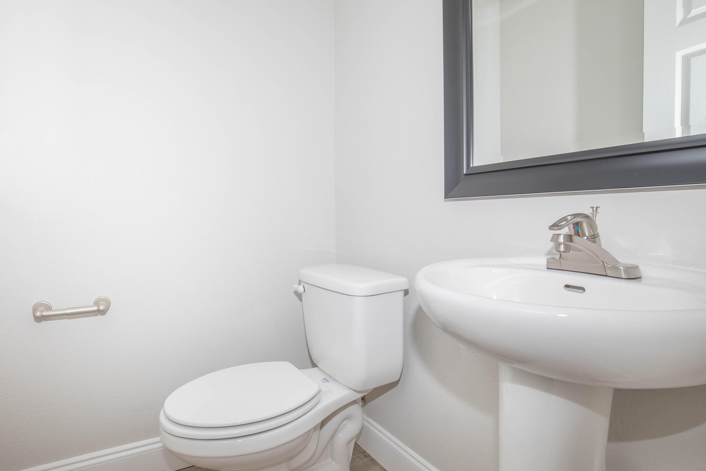 a white sink sitting next to a window