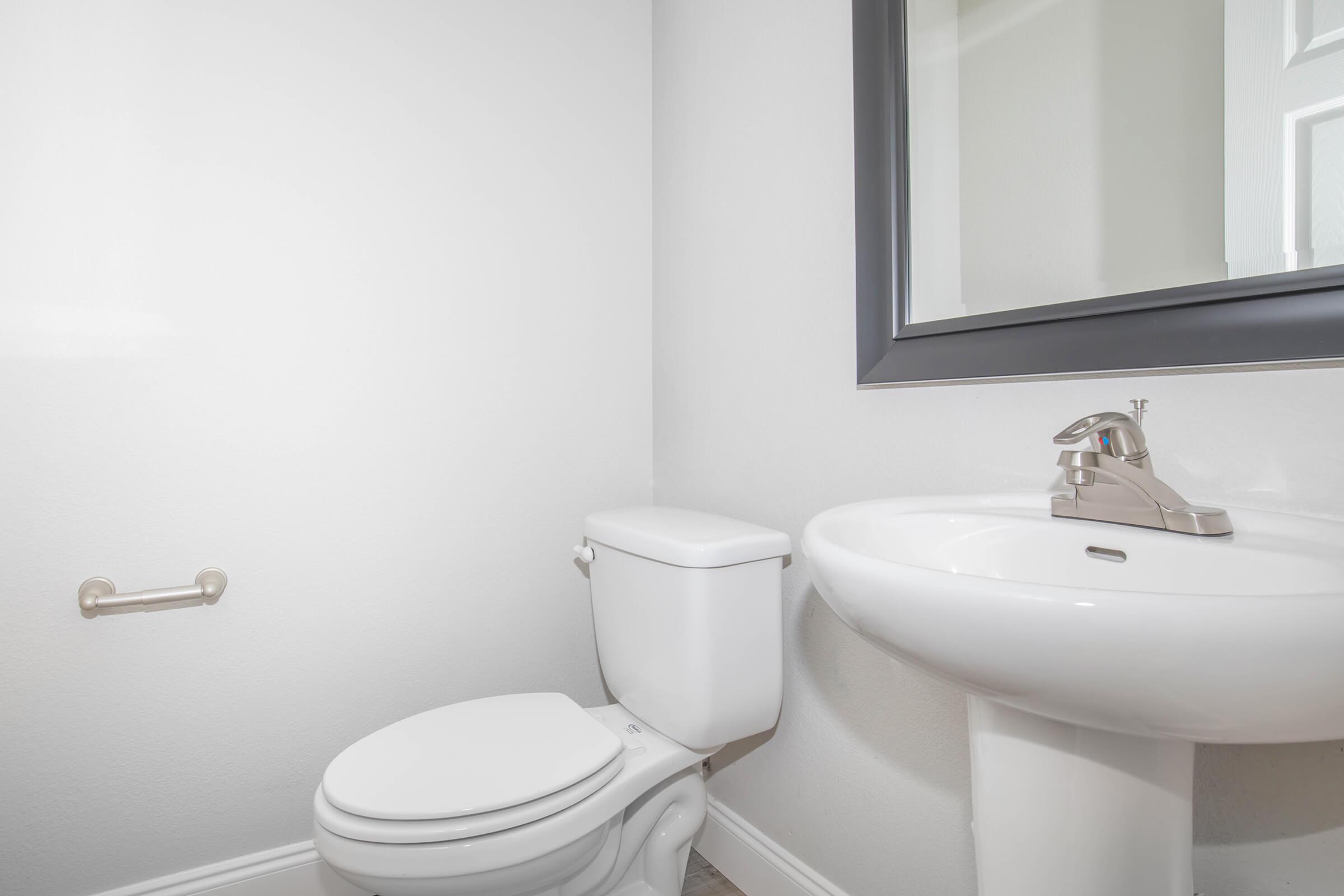 a white sink sitting under a window