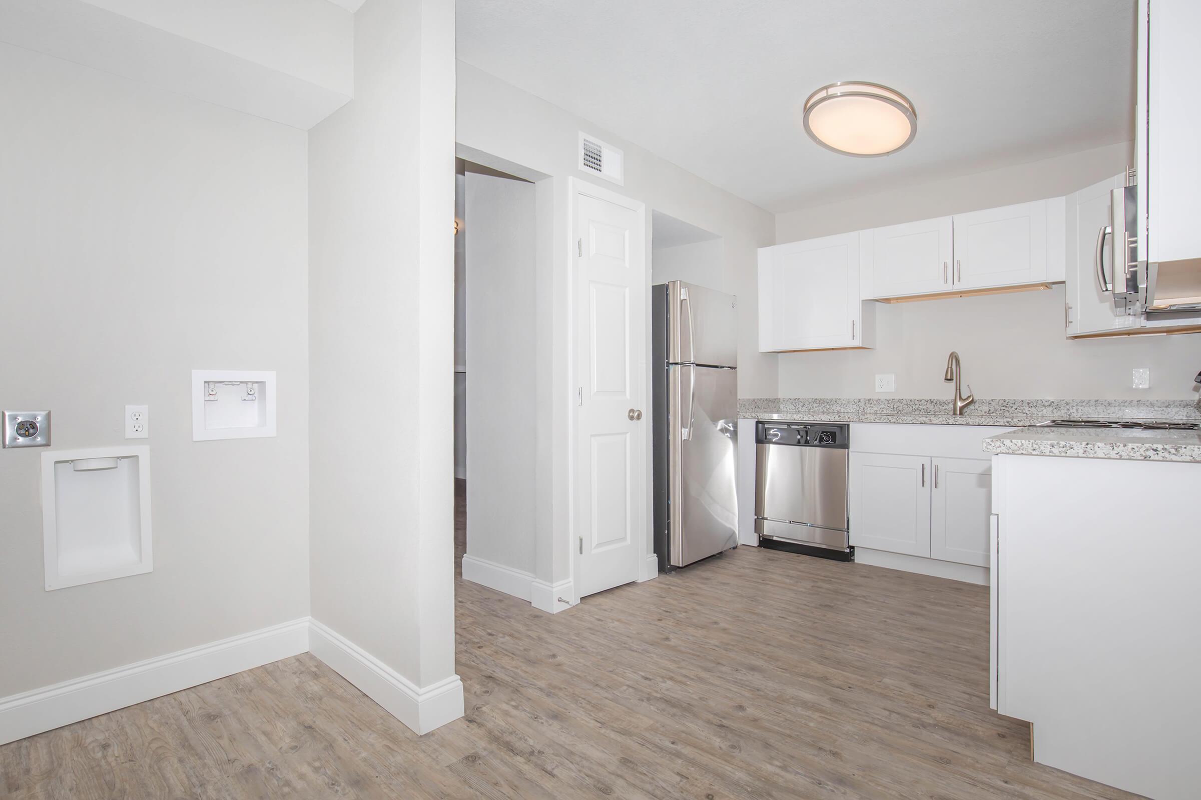 a kitchen with a sink and a mirror