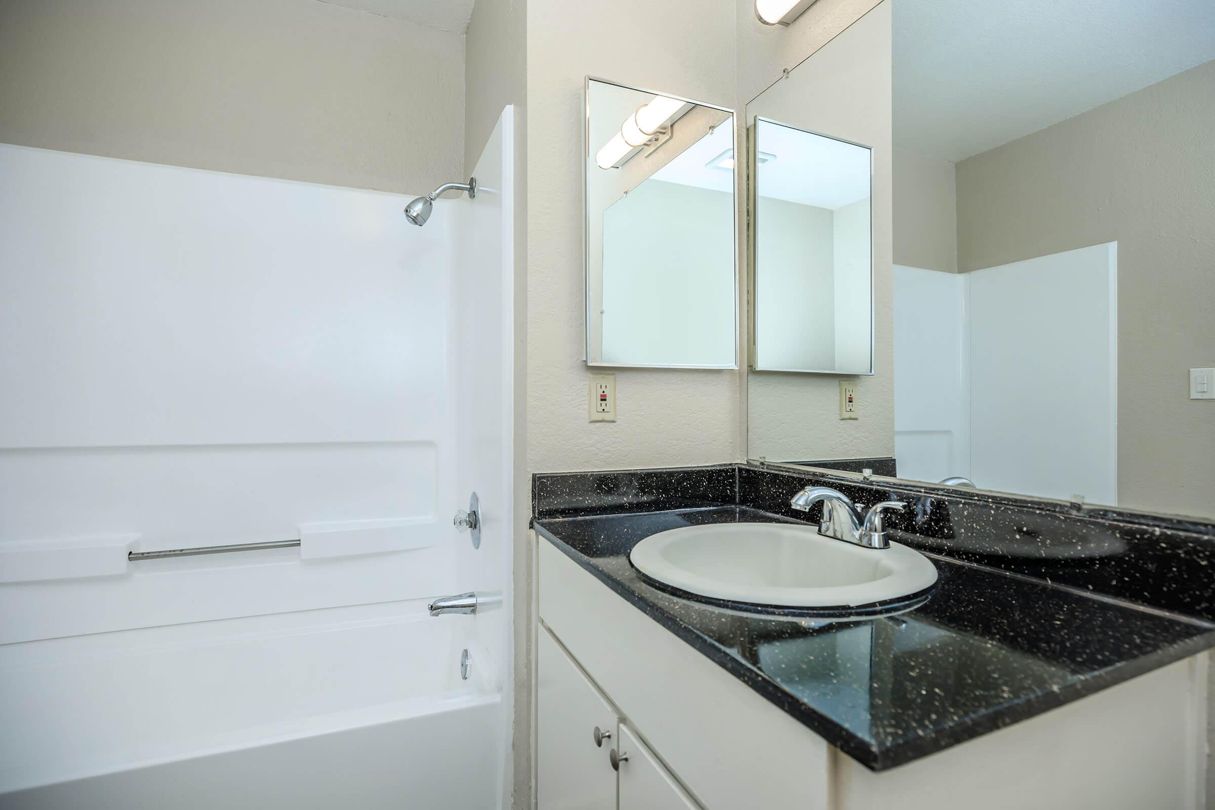 Bathroom with black countertops