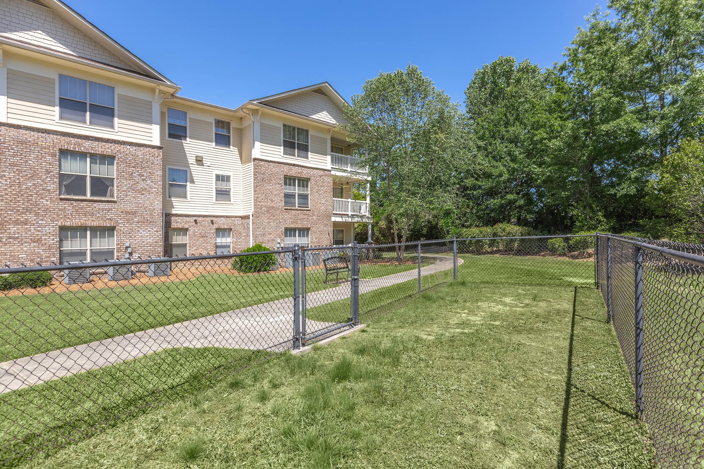 a house with a fence in front of a building