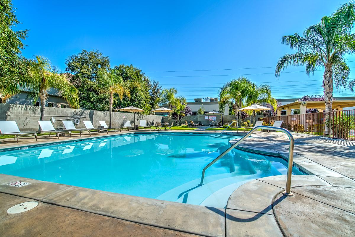 The community pool with yellow umbrellas