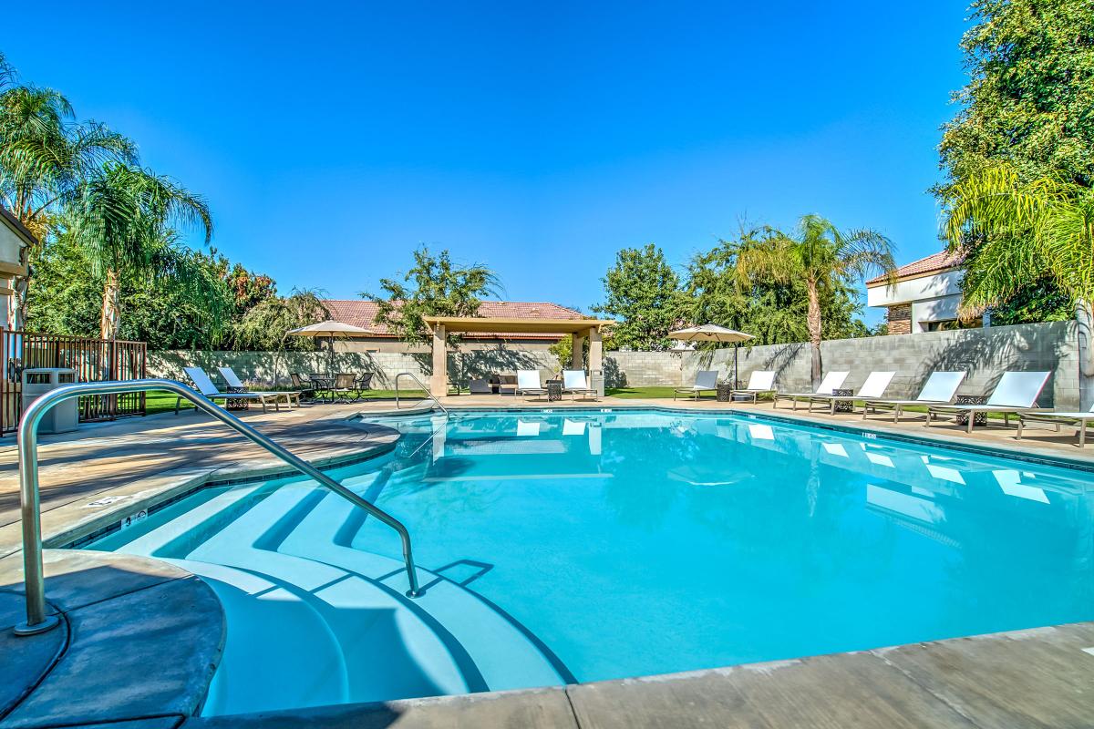 Community pool with white chairs