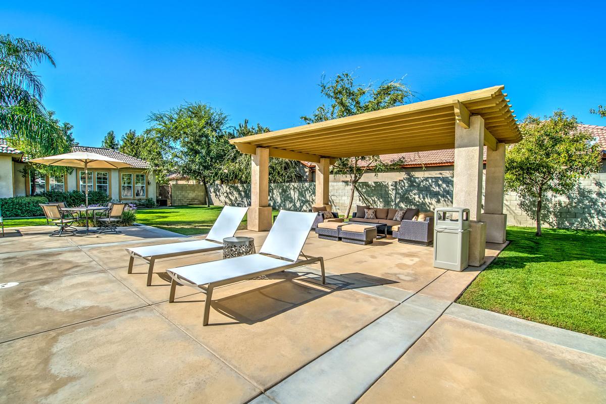 Couches and lounge chairs under a pergola