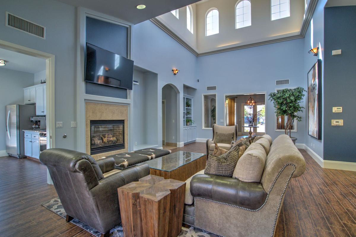 Community room with a fireplace and TV