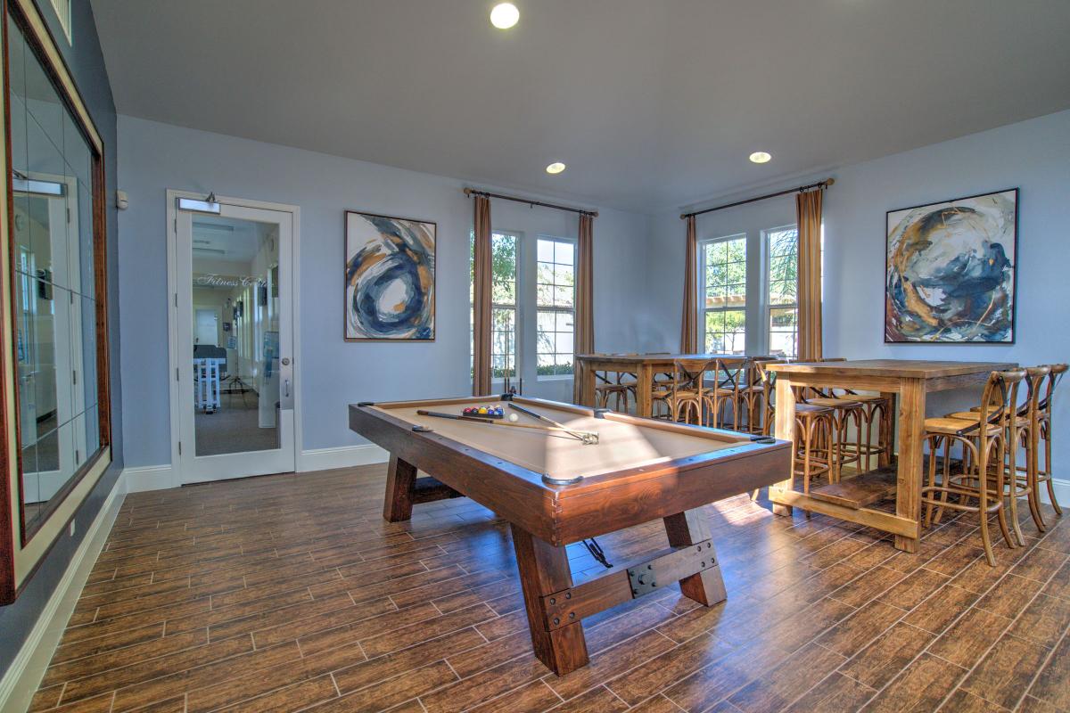 Chairs and tables next to the community pool table