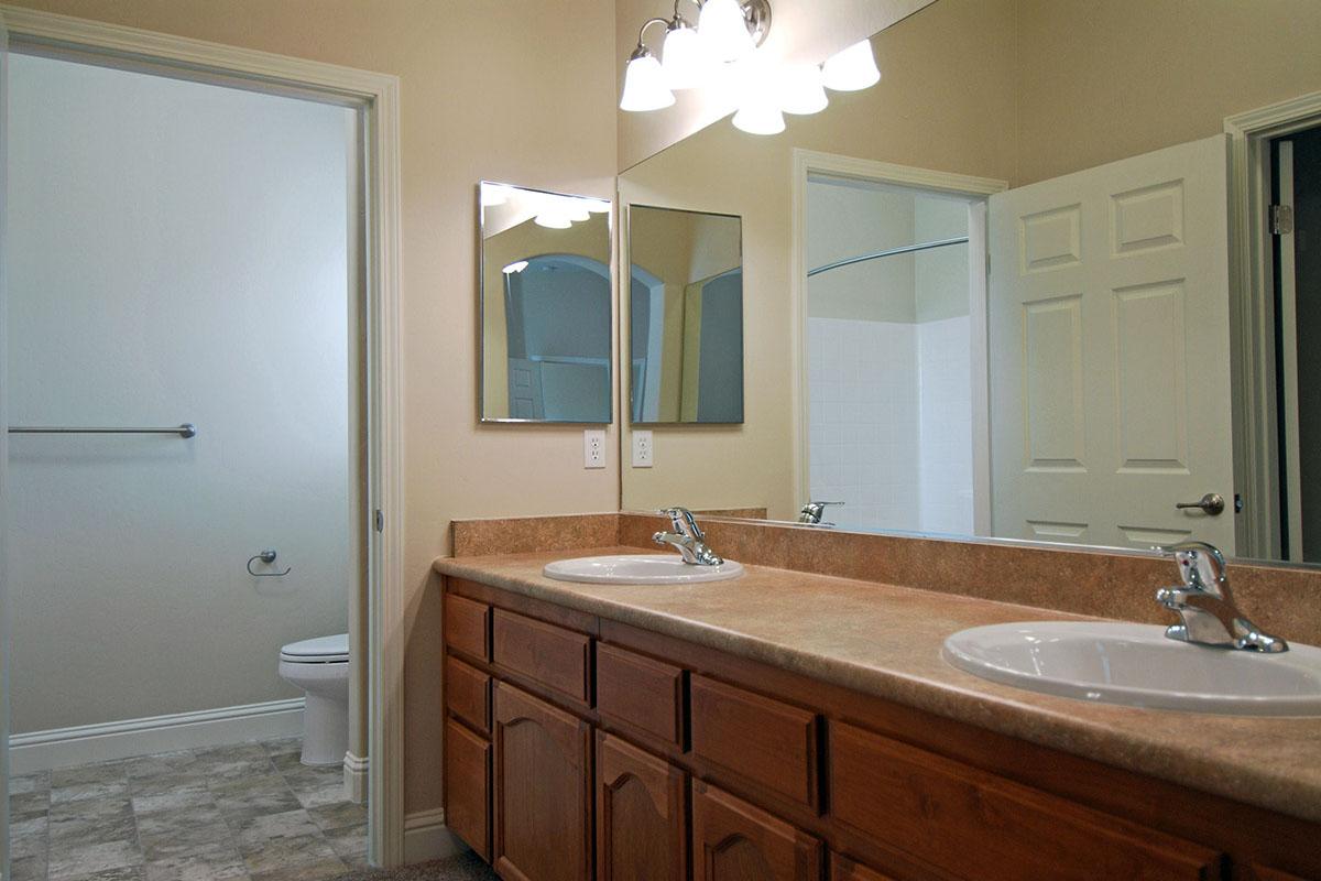 Bathroom with open door to powder room