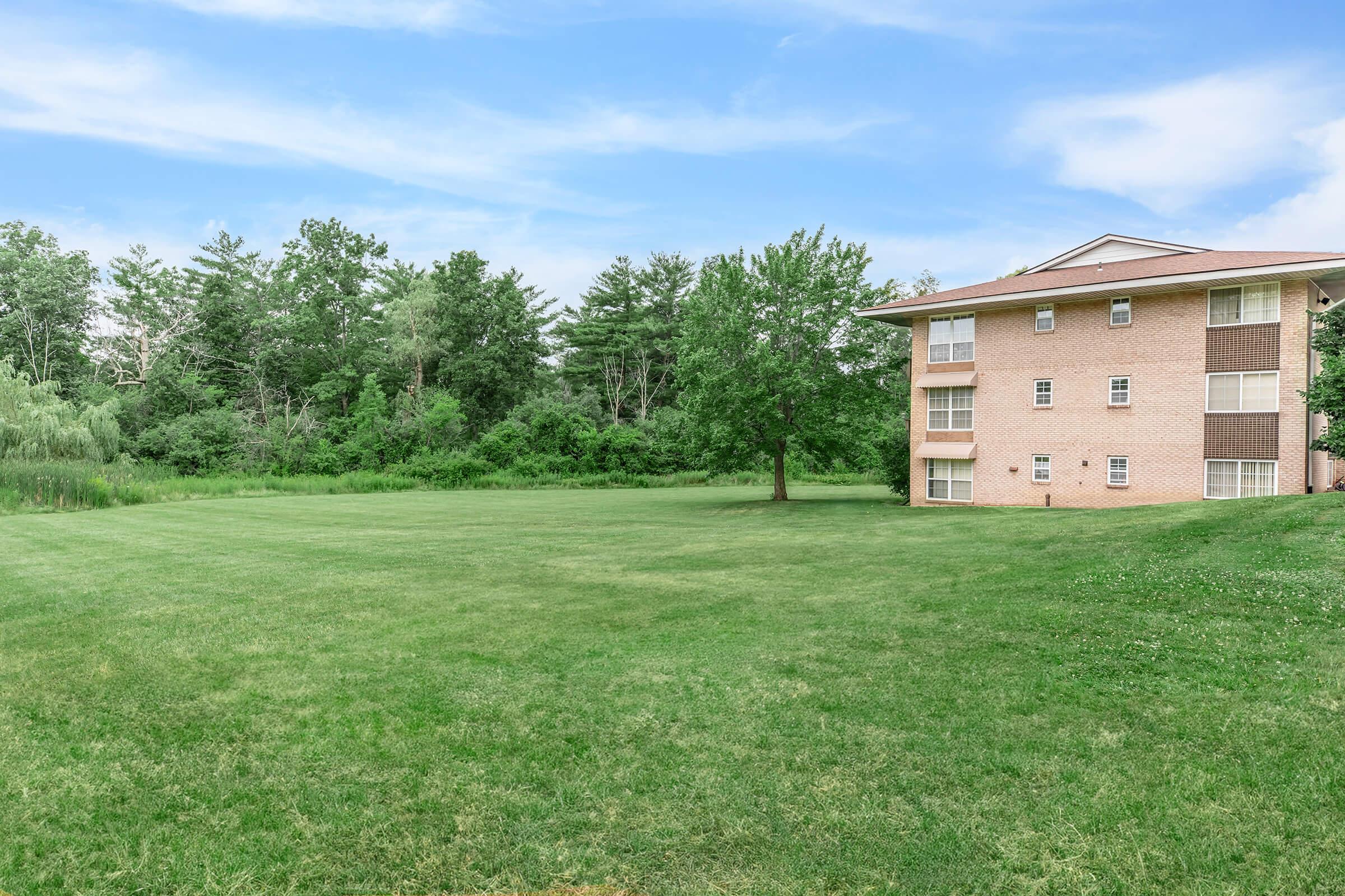 a building with a grassy field