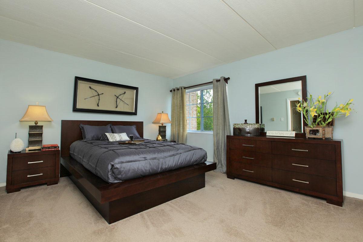 a living room with a bed and a television