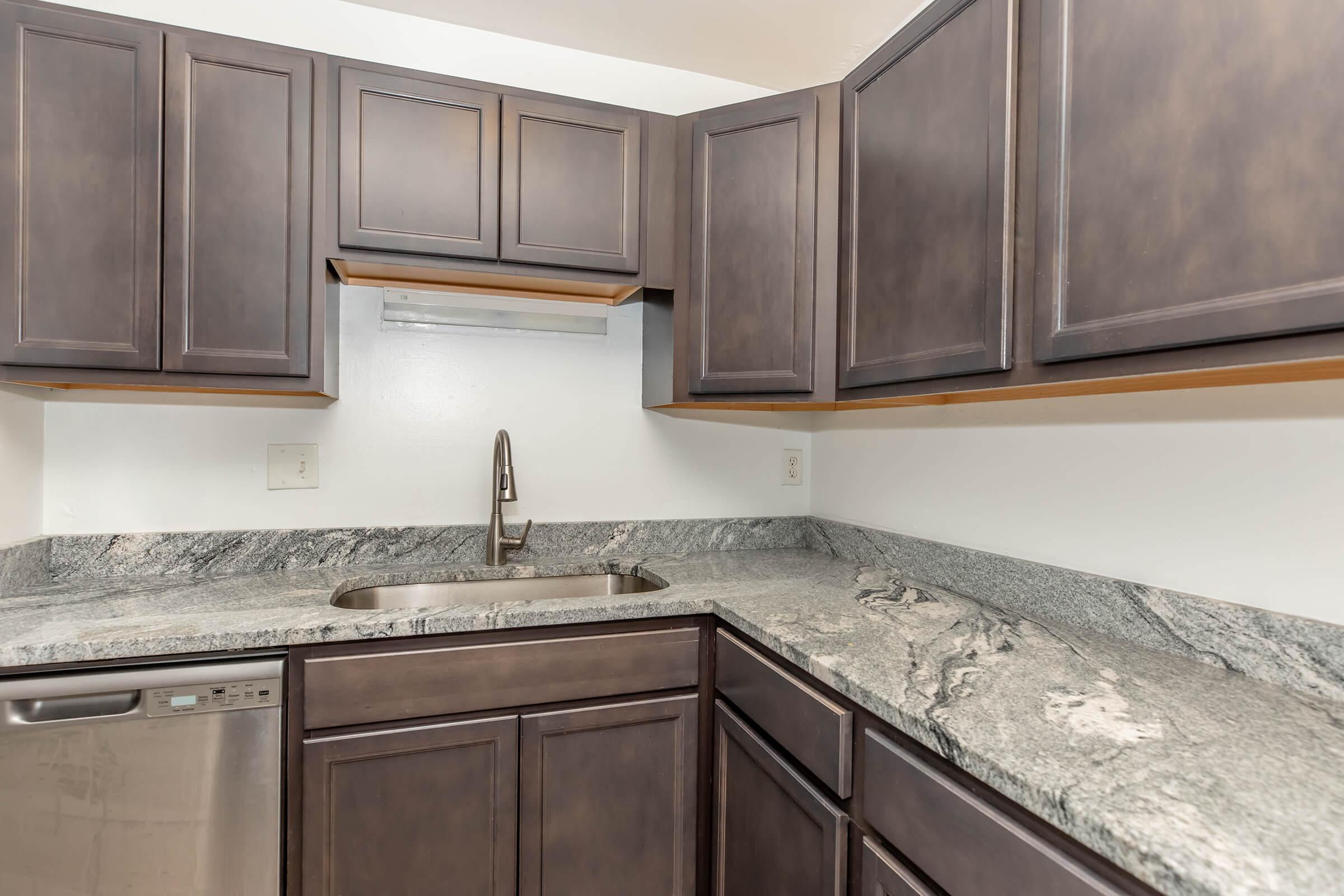 a kitchen with stainless steel appliances and wooden cabinets