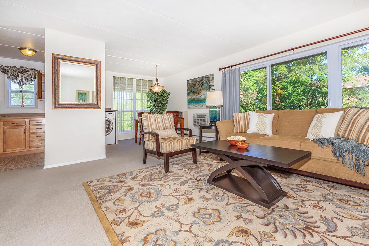 a living room filled with furniture and a large window