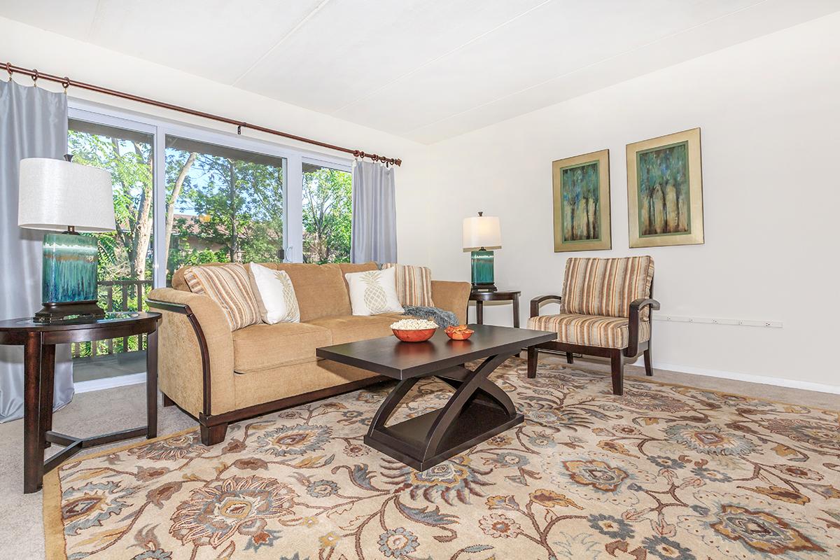 a living room filled with furniture and a large window