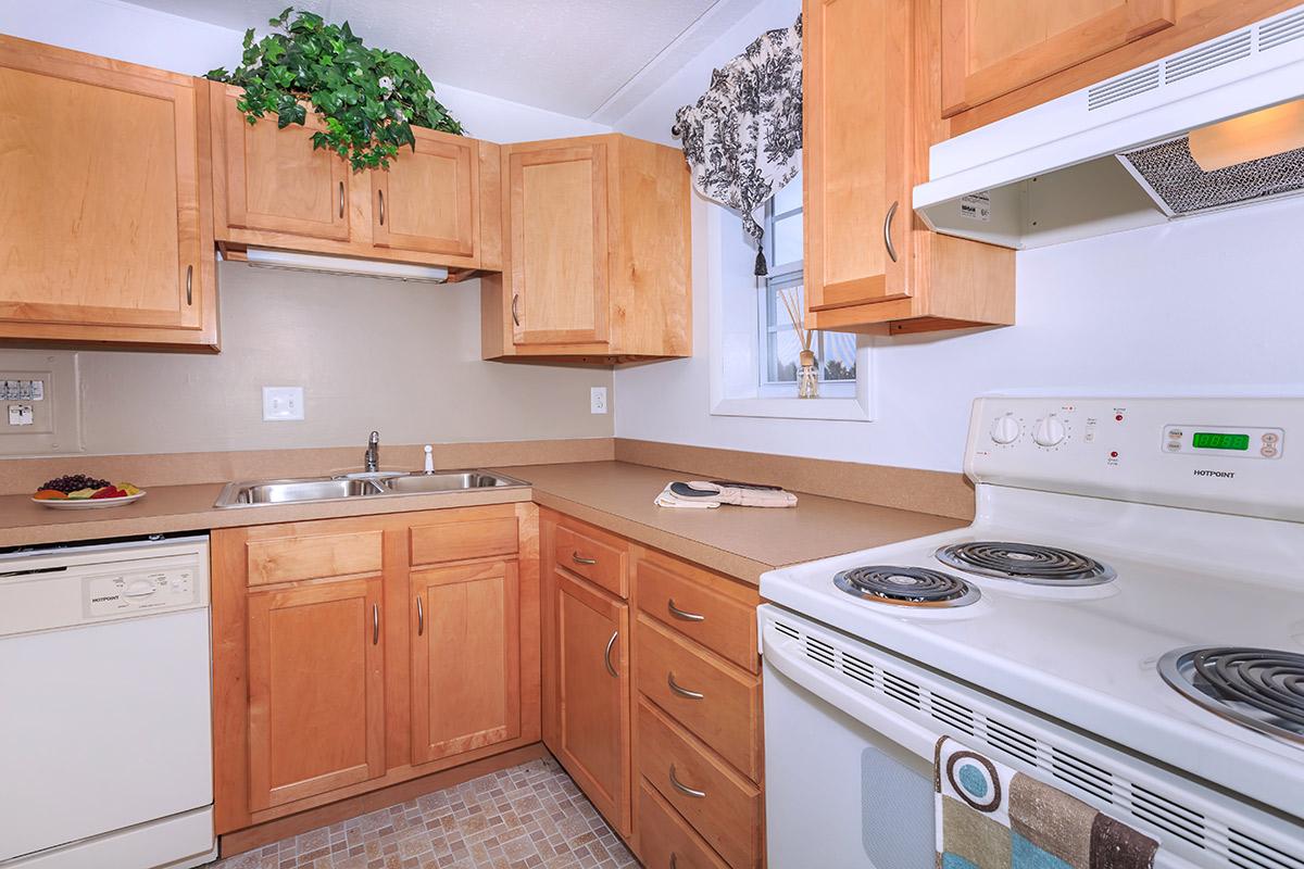 a stove top oven sitting inside of a kitchen