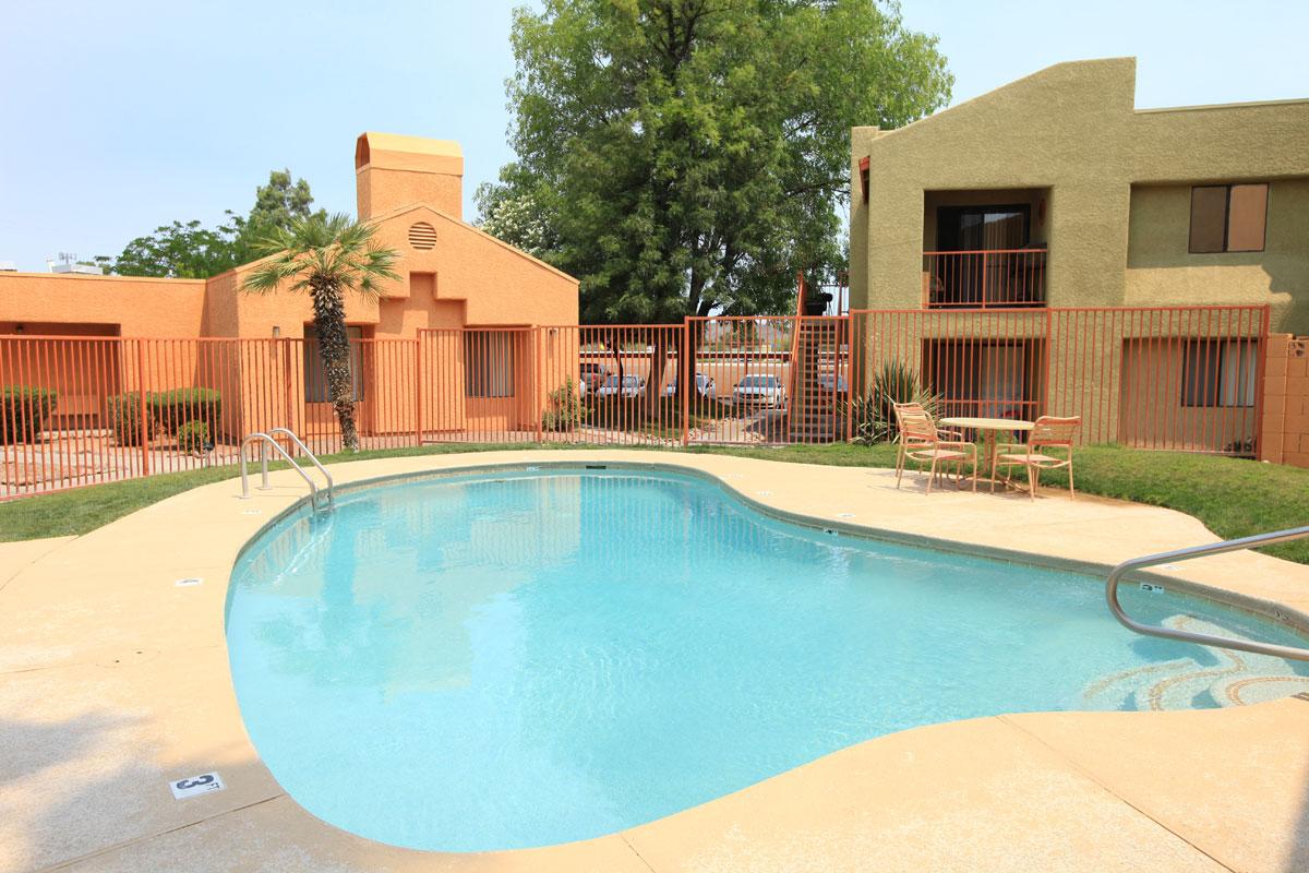 a house with a pool in front of a building